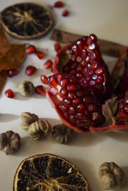 Close-up of premium dry fruits arranged elegantly on a dark green surface.