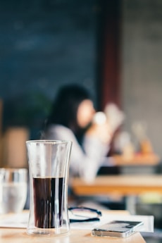 shallow focus photo of drinking glass with liquor