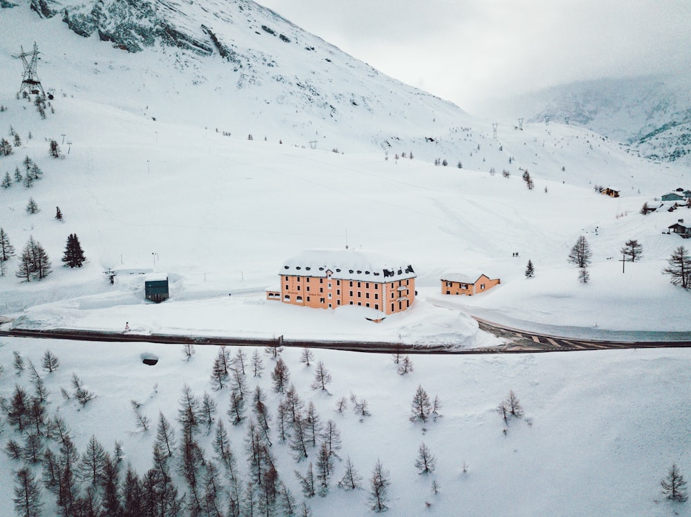 building on snowy mountain during daytime