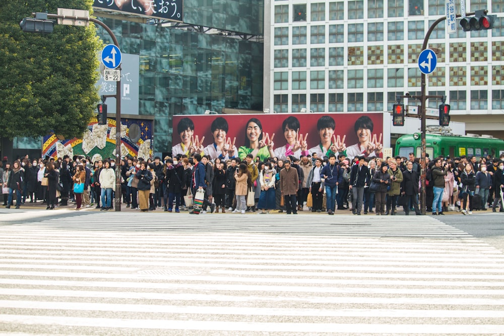 group of people standing on streetside at daytime