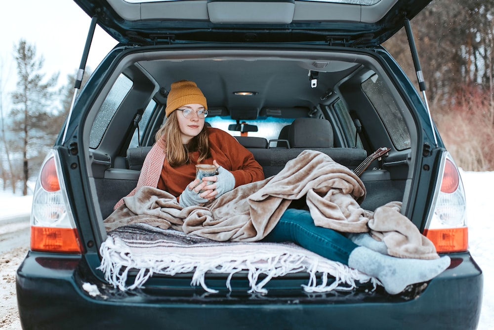 woman lying down on car compartment