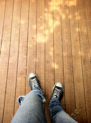 A pair of youthful, casual espadrilles resting on a sunlit wooden deck with soft natural tones.
