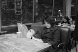 An inspiring person reading a book in a cozy café.