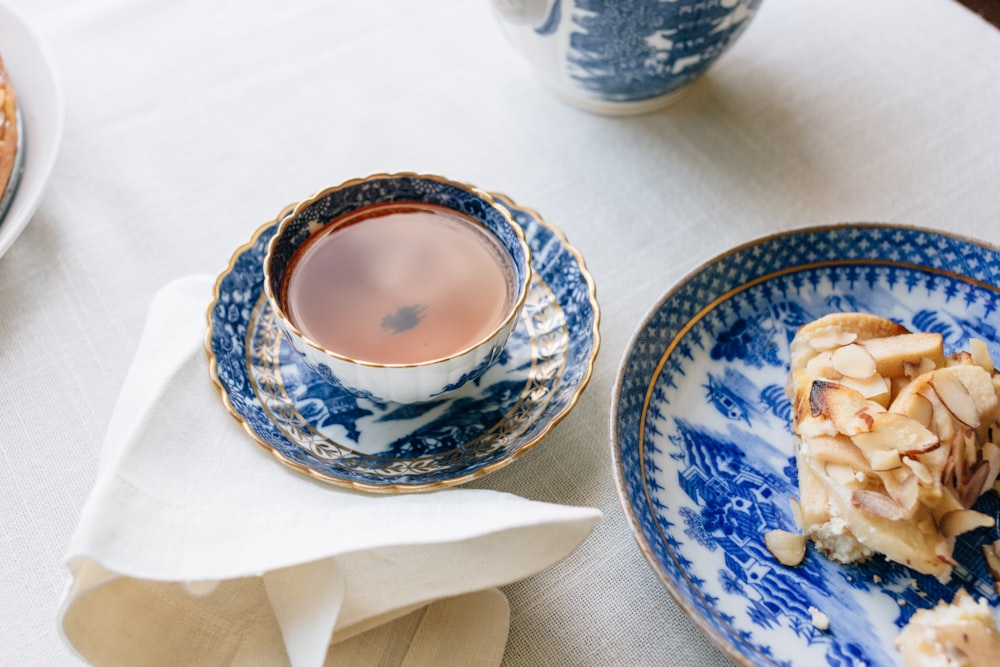 cup filled with brown liquid near plate