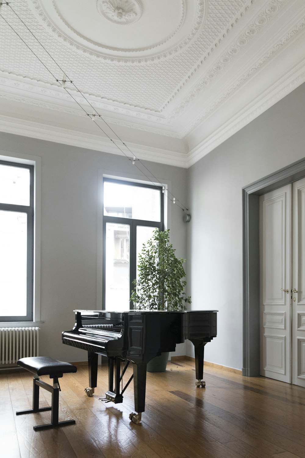 brown grand piano inside white room