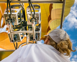 person wearing white top looking on machine