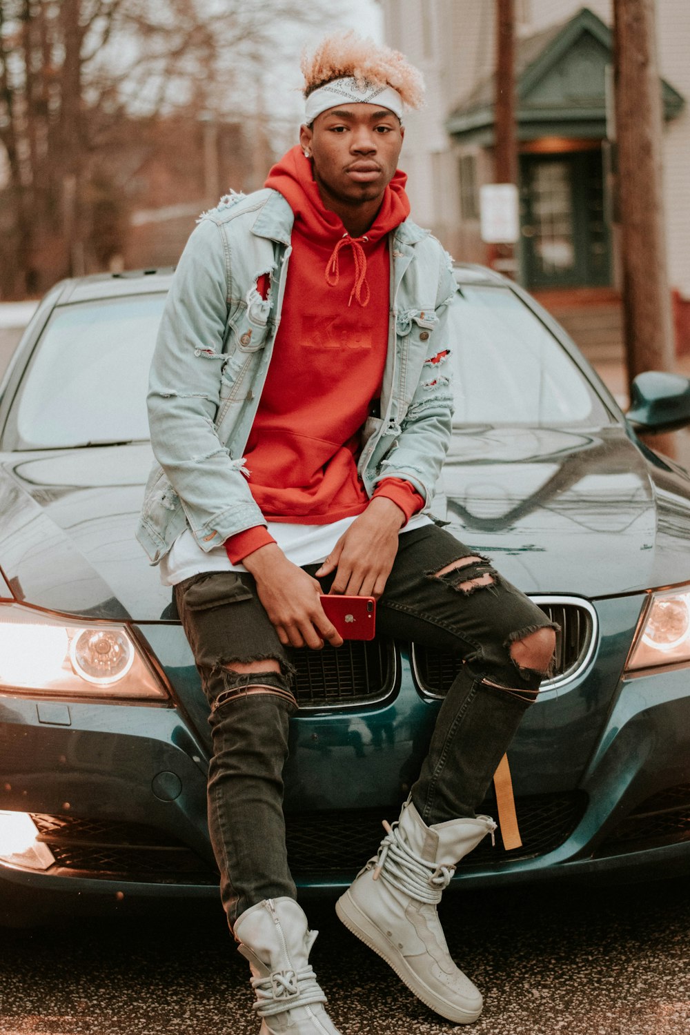 man sitting on green car