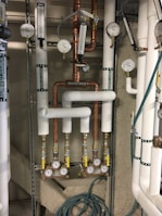 A freshly installed water heater in a neat utility closet with organized piping.