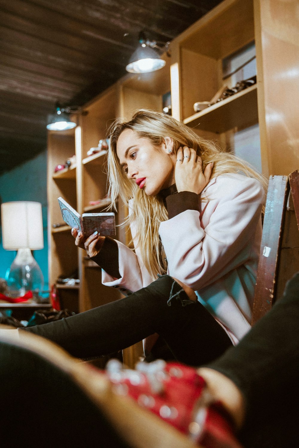 woman sitting on chair looking at mirror