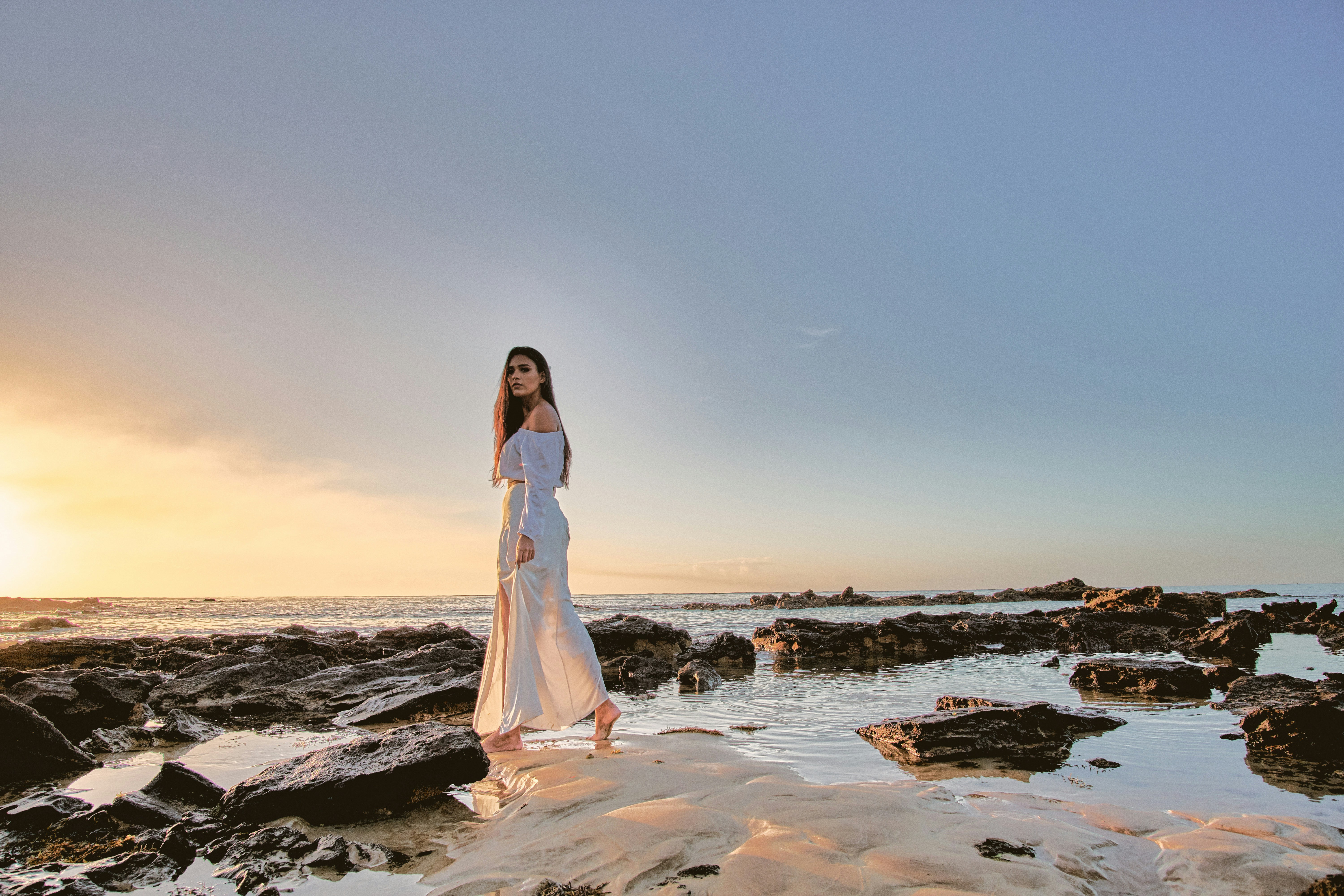 woman standing on body of water