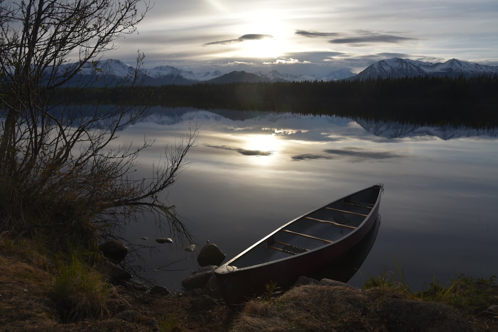 gray kayak on body of water