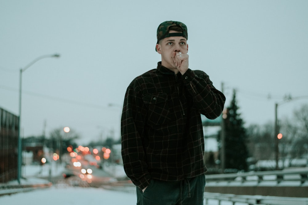 man wearing black and brown flannel shirt