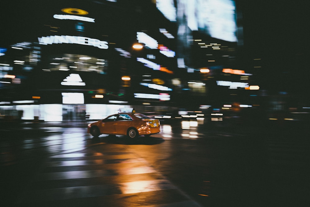 yellow sedan in front of building