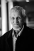black and white photo of man in black suit jacket