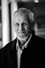 black and white photo of man in black suit jacket