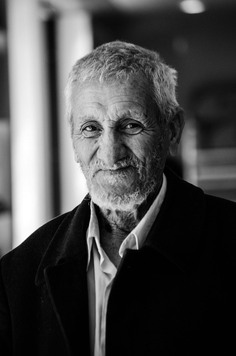 black and white photo of man in black suit jacket