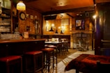 Bar corner with vintage decor and inviting stools.