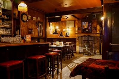 Small, welcoming bar interior with colorful decorations and ambient lighting.