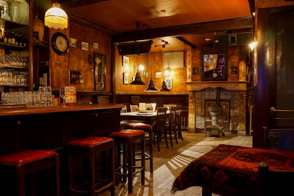 Cozy interior of a small neighborhood tapas bar with wooden tables and warm lighting.