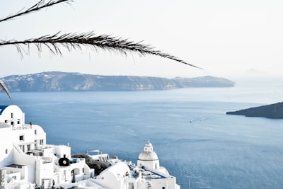 white concrete buildings near ocean during daytime greece google meet background