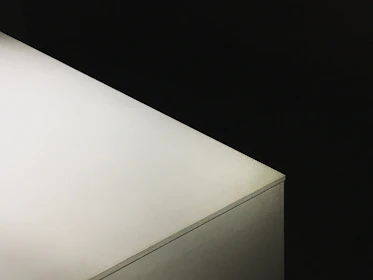 Close-up of the inverted pyramid and cube base, highlighting subtle shadows and the Scandinavian minimalist aesthetic.