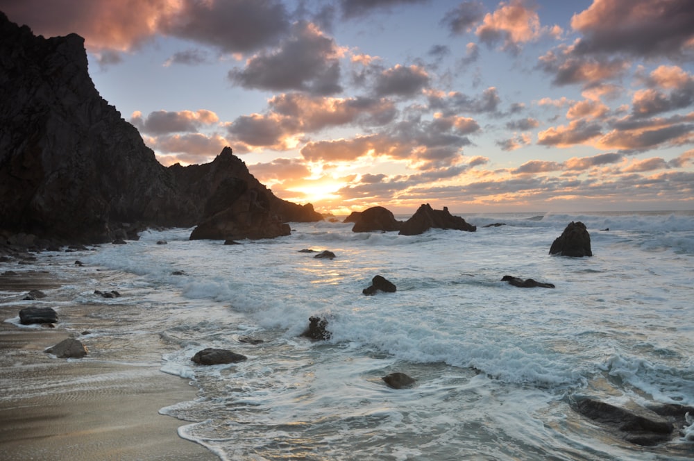 photo of seashore near rocks