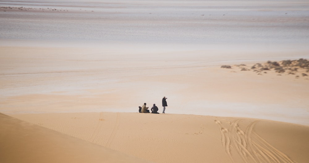 three person standing at the middle of the field