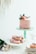 A vibrant display of assorted cakes in soft pink colors.