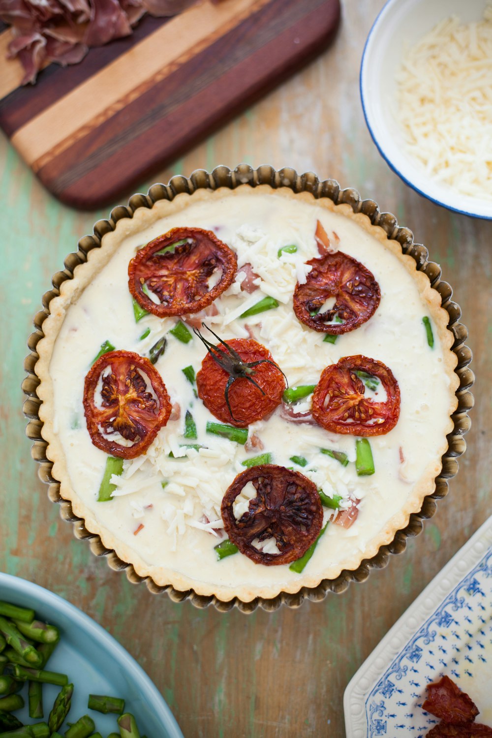 baked pastry surrounded by plates, bowls, and board