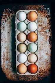 A vibrant display of organic eggs in various colors.