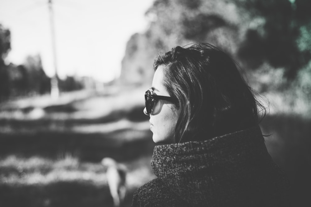 a woman wearing sunglasses looking off into the distance