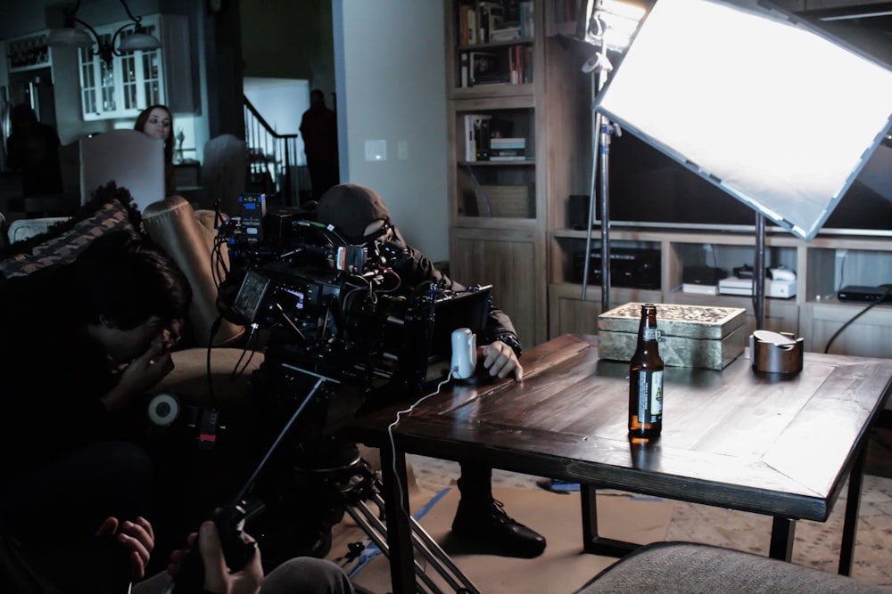 man taking a video on table near studio lamp