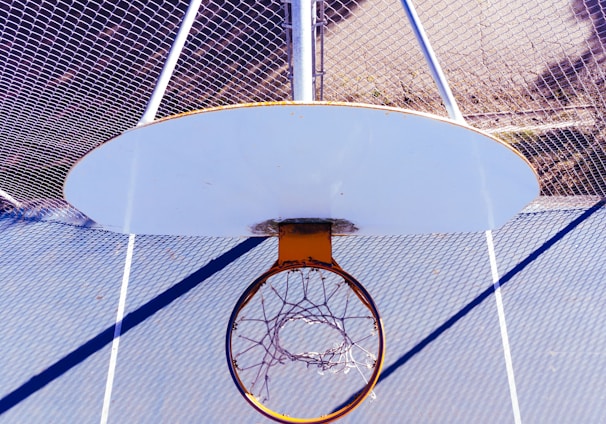 white and orange basketball hoop during day
