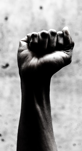 person's right fist grayscale photography