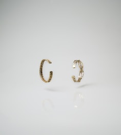 Minimalist display of men's bracelets in gold and silver tones