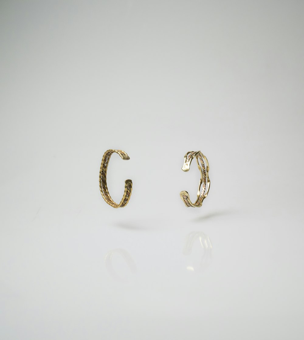 pair of gold-colored earrings