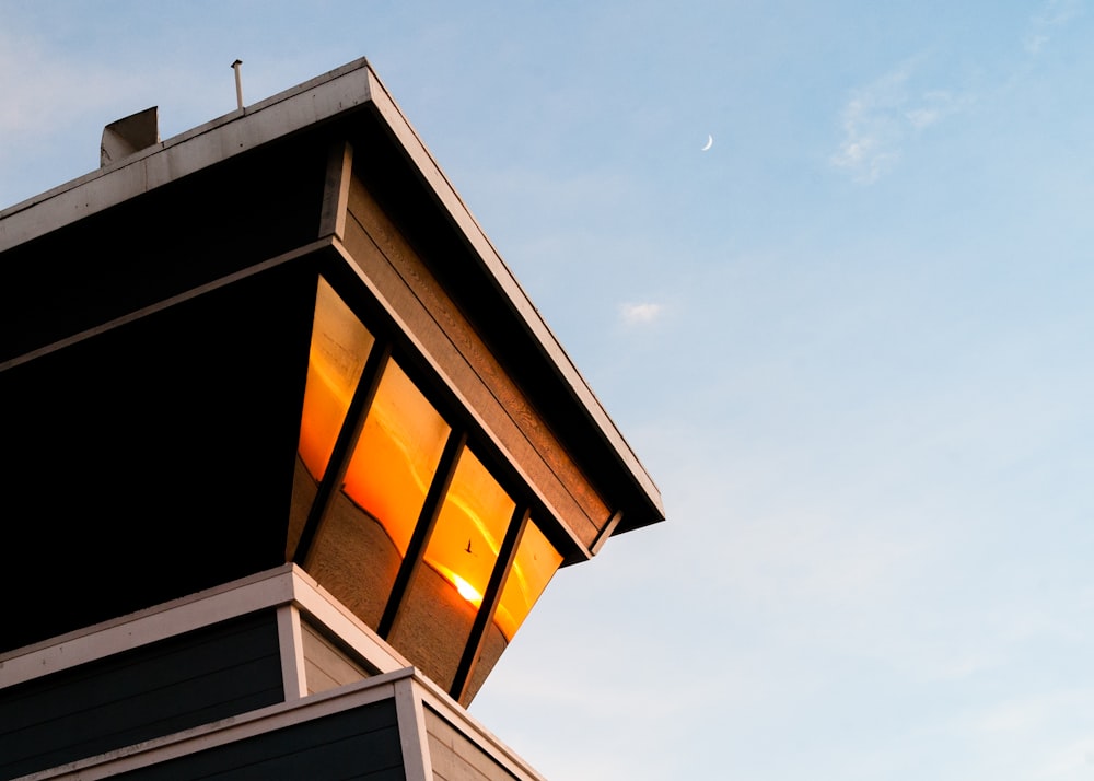 a tall building with a lit up window on top of it