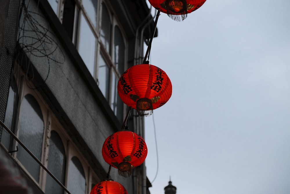 red oriental lamps hanged near building