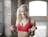 woman holding red dumbbells