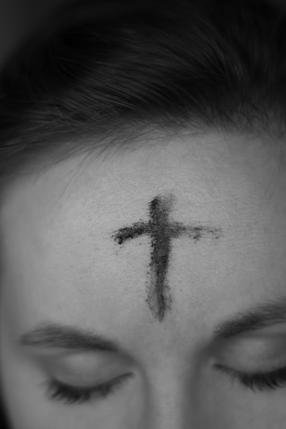 cross on person's forehead