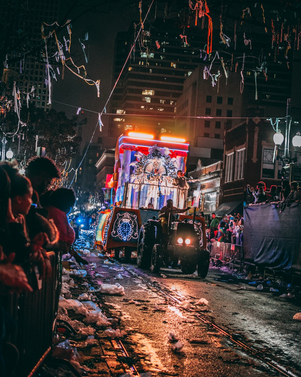 person riding on tractor surrounded by peoples