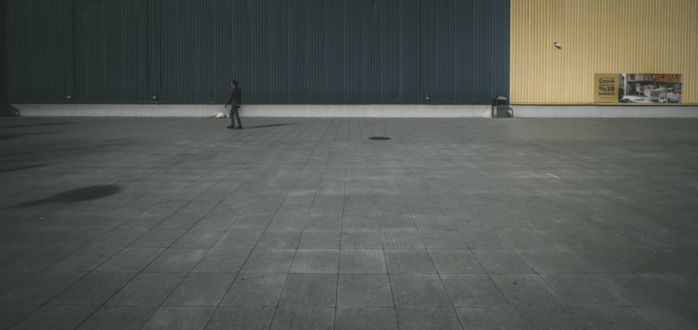 person walking on concrete pavement