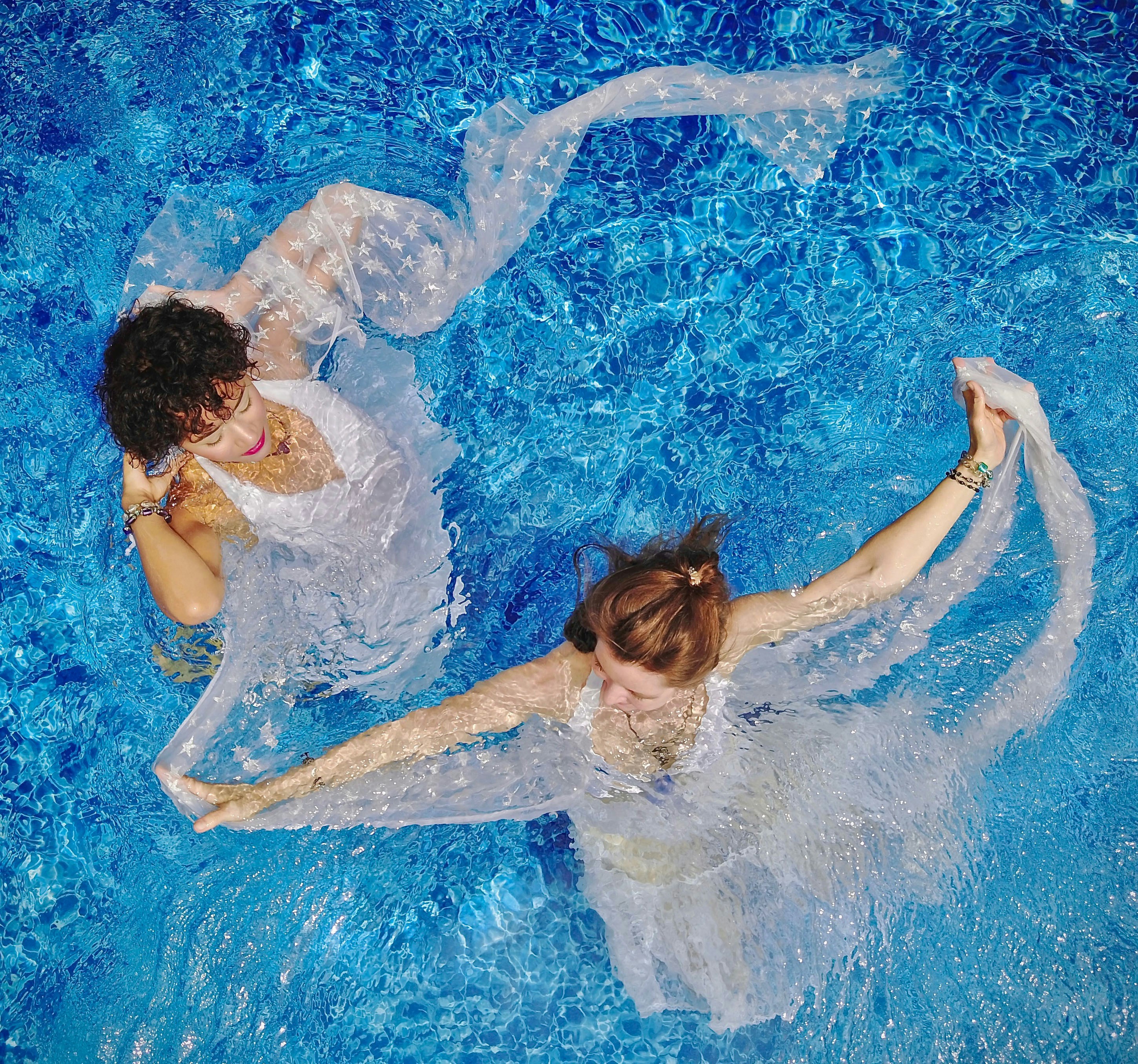 During an Underwater Fashion shoot two girls swirled around their dresses for a top-down aerial view with my drone.