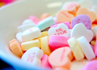 assorted hear-shape candies on white bowl