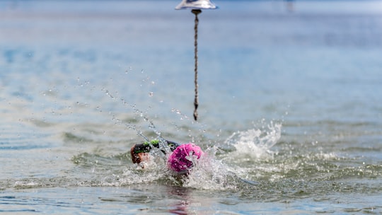 person in pink cap in body of water in Villa La Angostura Argentina