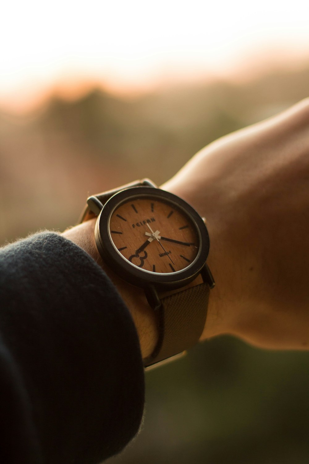 person wearing black analog watch