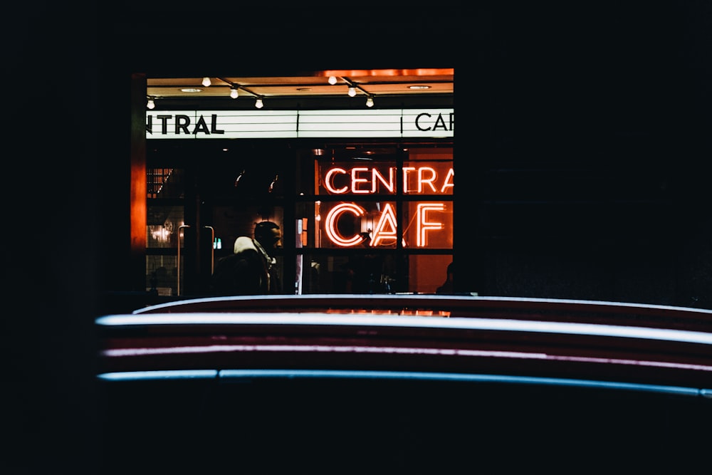 lighted central cafe neon signage at night time