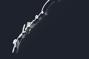 A stylish TV series poster with bold typography and a dark navy background glowing with cyan highlights