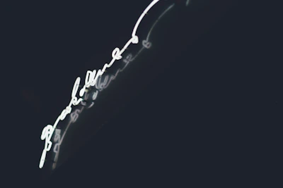 Custom UV printed acrylic sign glowing under bright light in the studio.