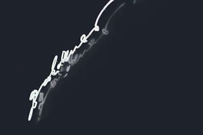 A dynamic shot of a glowing violet light accent highlighting a modern typography layout on a dark background.